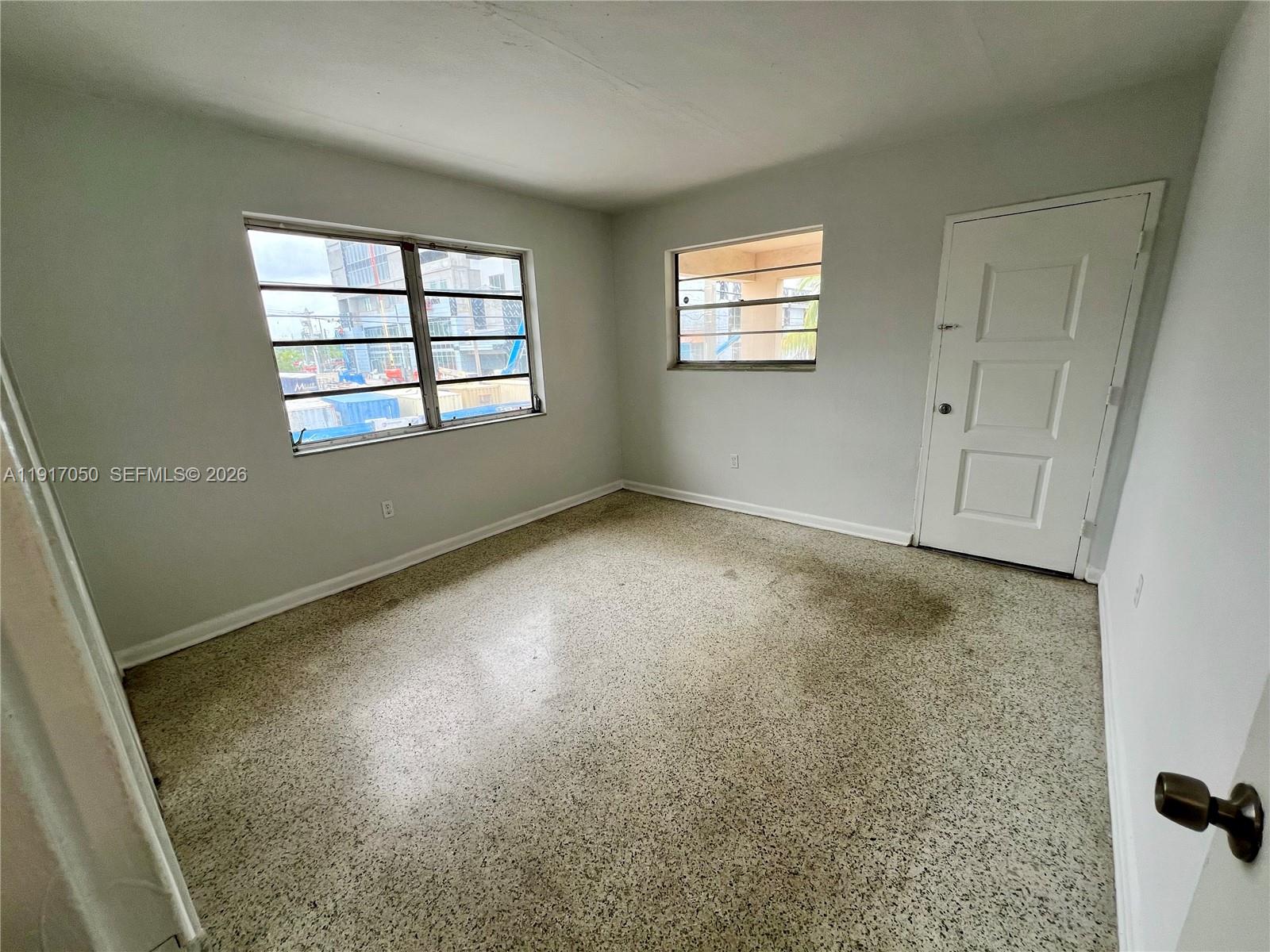 675 Southwest 7th Avenue, Unit 12 Miami, FL 33130 - Photo 9 of 13 an empty room with windows