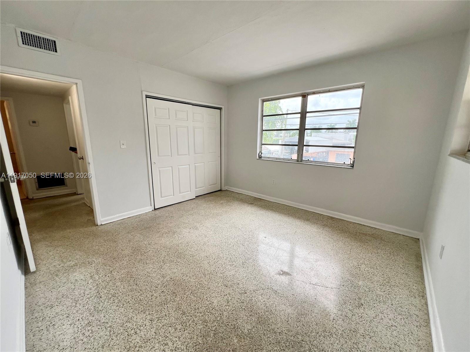 675 Southwest 7th Avenue, Unit 12 Miami, FL 33130 - Photo 10 of 13 an empty room with windows