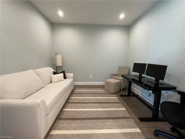 a bedroom with furniture and a lamp