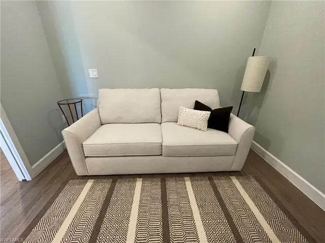 a living room with furniture and a rug