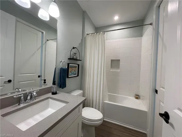 a bathroom with a sink toilet double vanity and shower