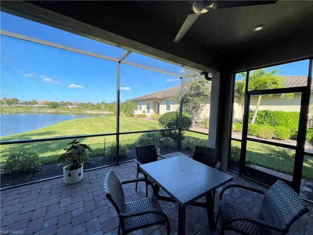 a view of a patio with lawn chairs