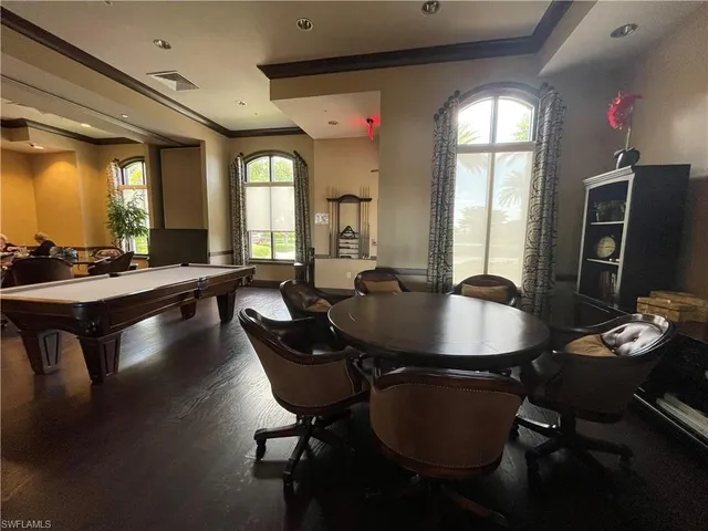 a dining room with furniture and wooden floor