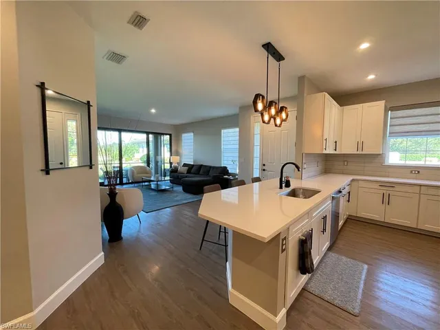 a large white kitchen with a large window