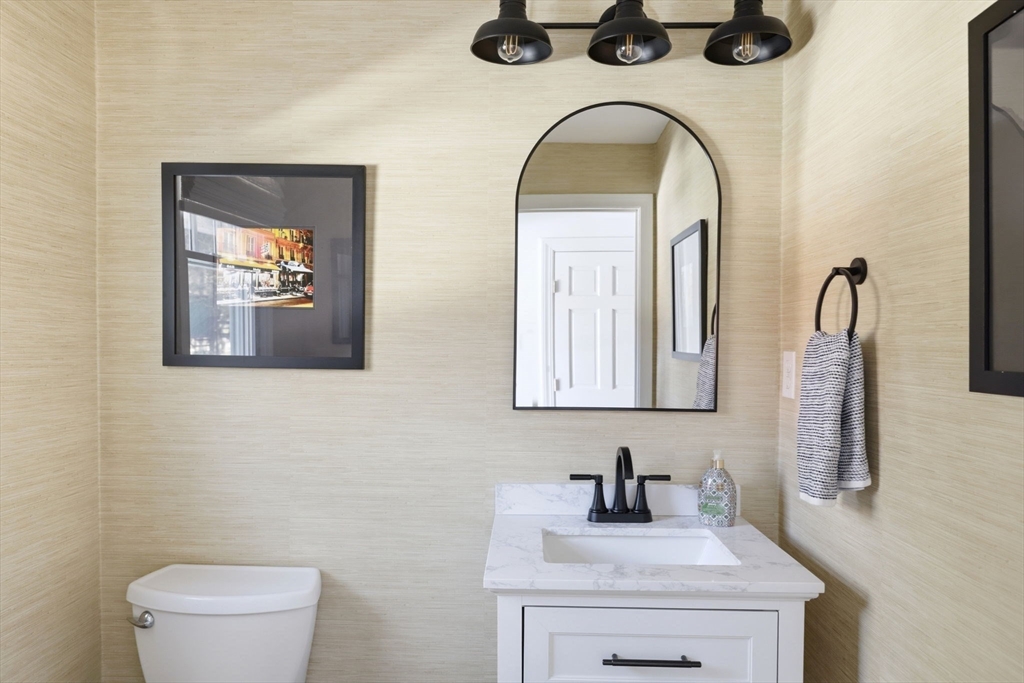 24 Ridge Hill Road Scituate, MA 02066 - Photo 19 of 38 a bathroom with a sink a toilet and mirror
