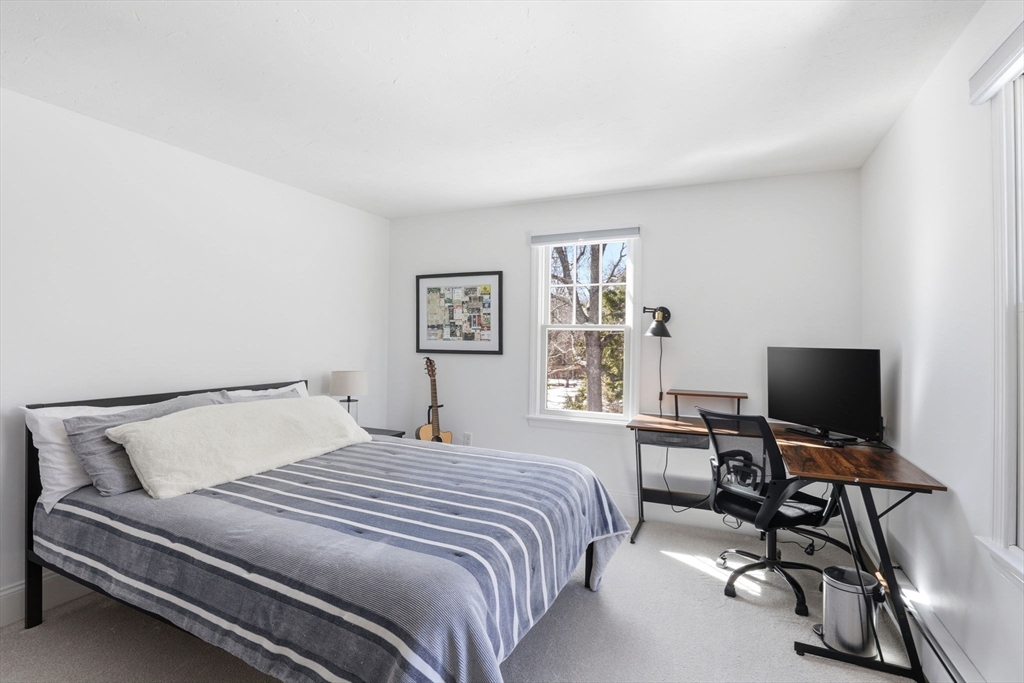 24 Ridge Hill Road Scituate, MA 02066 - Photo 23 of 38 a bedroom with a bed and a flat screen tv