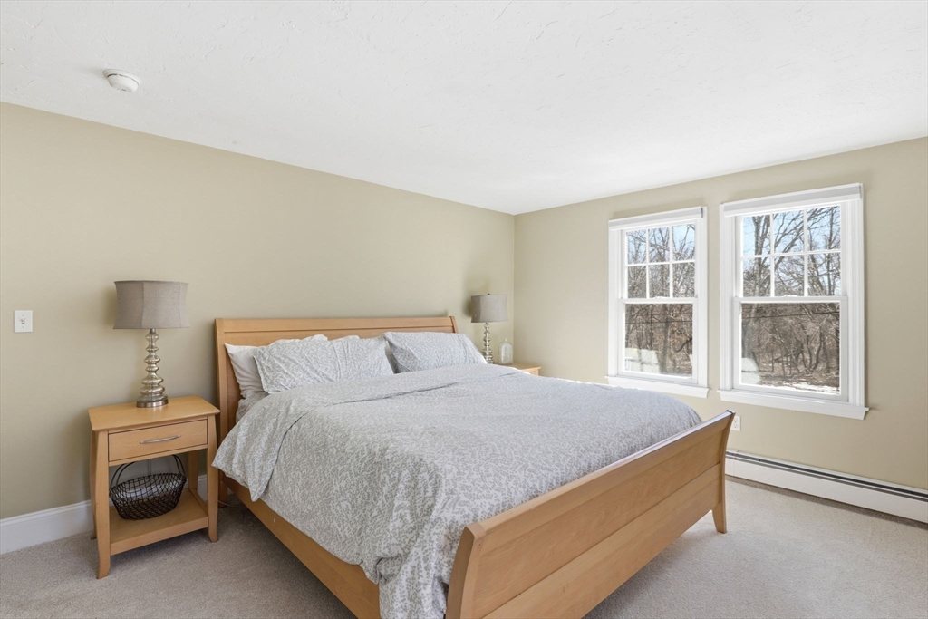 24 Ridge Hill Road Scituate, MA 02066 - Photo 24 of 38 a large bed sitting in a bedroom next to a window