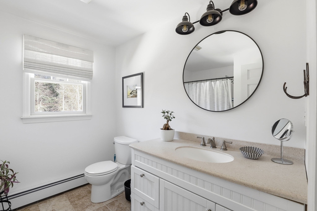 24 Ridge Hill Road Scituate, MA 02066 - Photo 26 of 38 a bathroom with a toilet a sink and a mirror