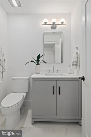 a dining room with wooden floor a chandelier a wooden table and chairs