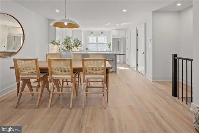a kitchen with granite countertop a sink cabinets and wooden floor
