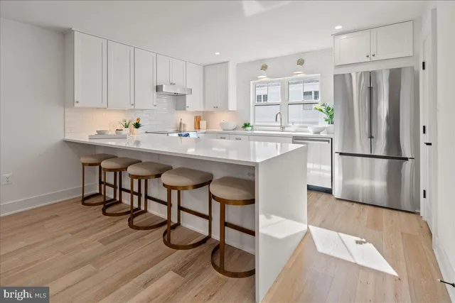 a kitchen with cabinets appliances and a sink