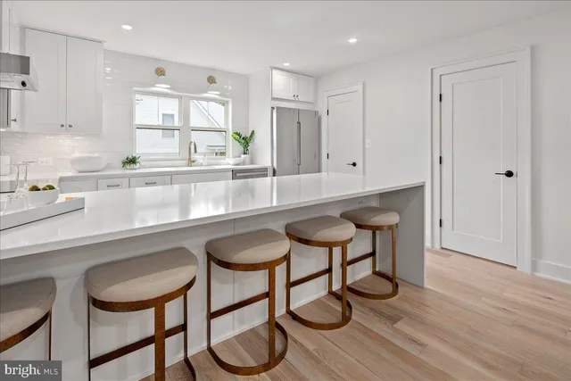 a living room with furniture kitchen view and a dining table