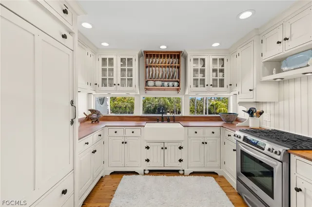 a kitchen with stainless steel appliances granite countertop a stove and a sink