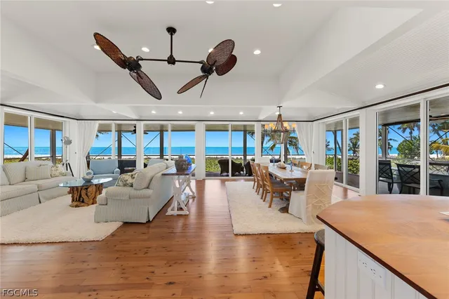 a living room with lots of furniture and a large window