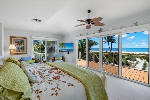 a bedroom with a bed and a large window with the outer view