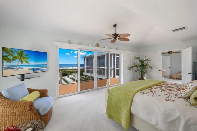 a spacious bedroom with a bed and a flat screen tv