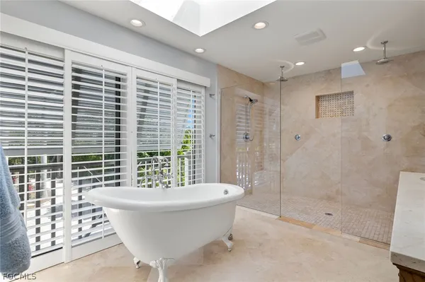 a bathroom with a bathtub and shower