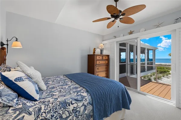 a bedroom with a bed and glass walk in closet