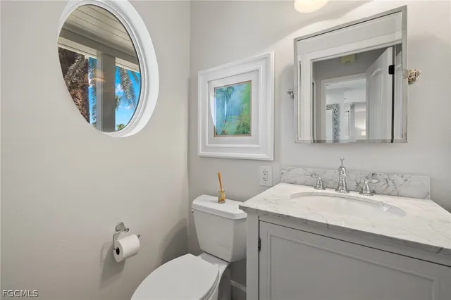 a bathroom with a toilet a sink and mirror