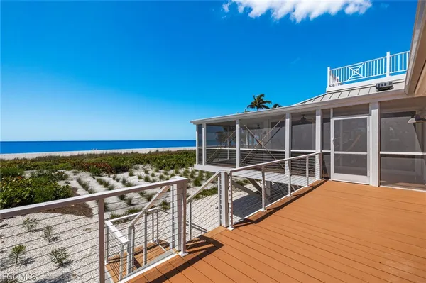 a view of a balcony with wooden floor and city view