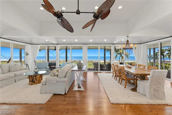 a living room with lots of furniture and view of kitchen