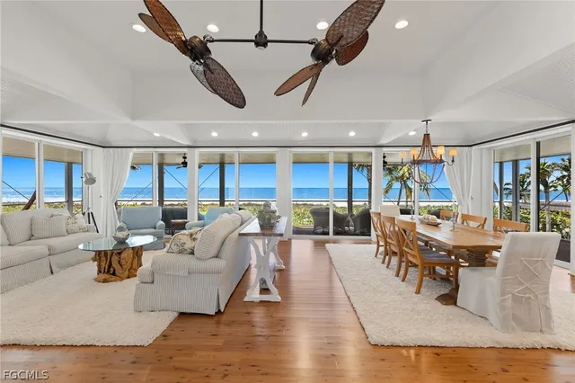 a living room with lots of furniture and view of kitchen
