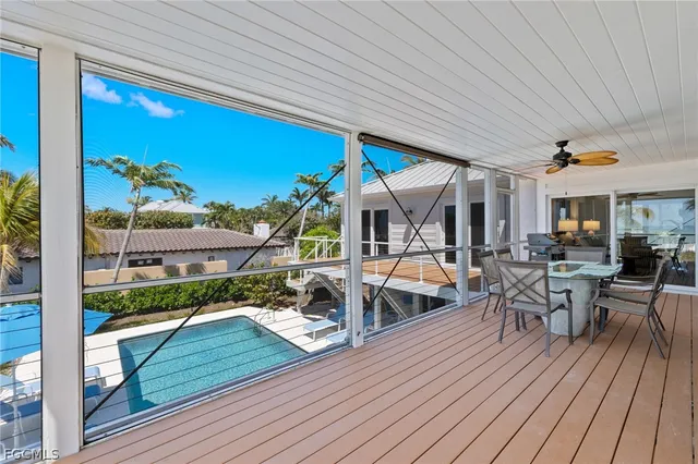 a view of a patio with table and chairs with wooden floor