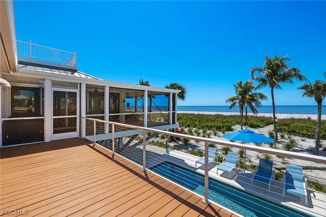 a view of balcony with wooden floor and fence