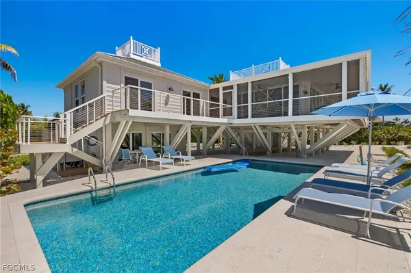 a view of a house with backyard porch and sitting area