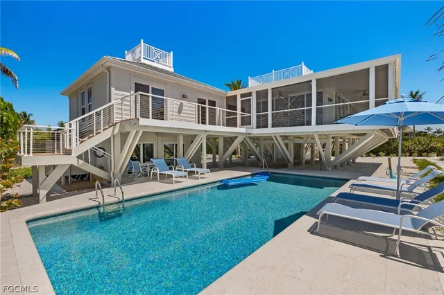 a view of a house with backyard porch and sitting area