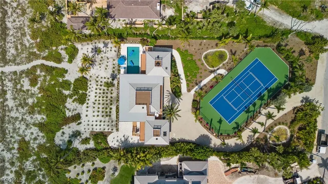 an aerial view of a house with a yard and garden