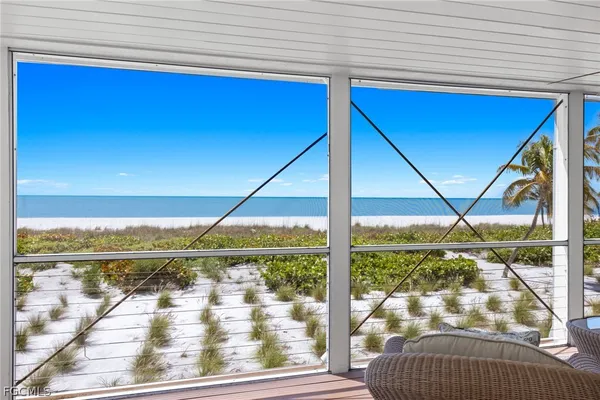 a view of a balcony next to a yard