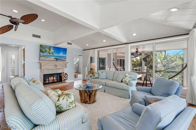 a living room with furniture fireplace and a large window