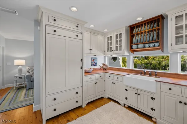 a kitchen with cabinets appliances and a window