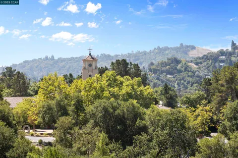 a view of a balcony next to a yard