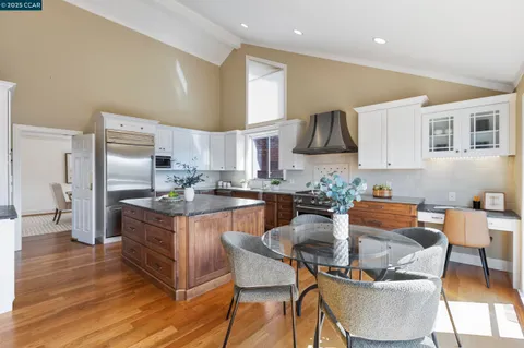 a kitchen with stainless steel appliances granite countertop a sink a stove and a window