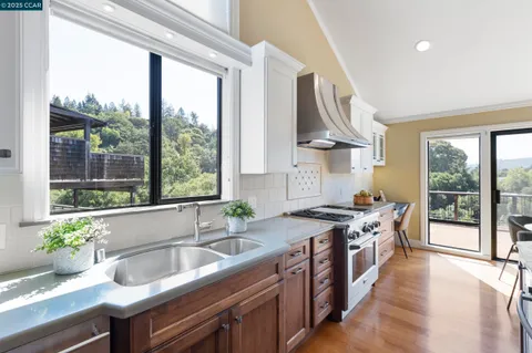 a dining room with wooden floor and a chandelier