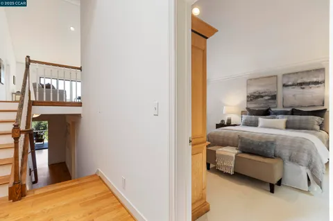 a view of a hallway with wooden floor and closet