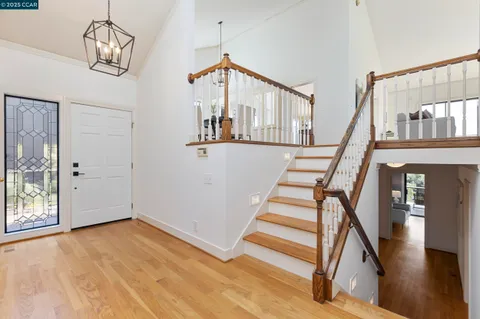 a living room with furniture a fireplace and a large window