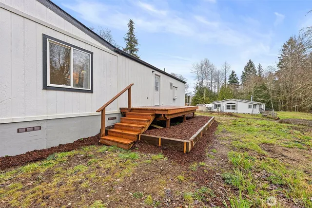 a backyard of a house with table and sofas