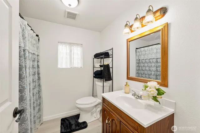 a bathroom with a sink toilet and shower