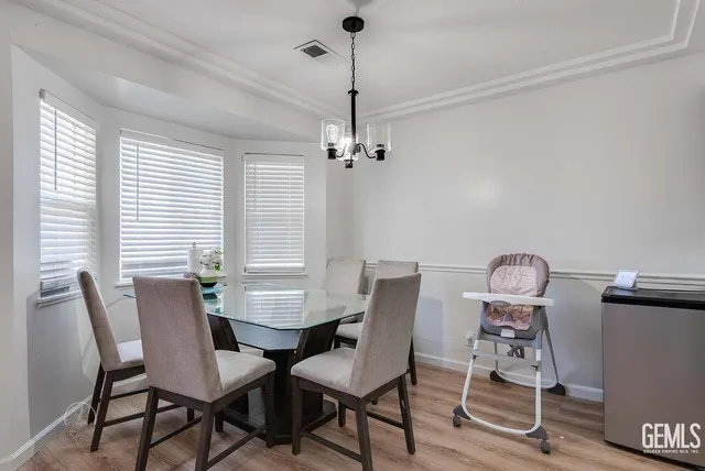 a view of a dining room with furniture and chandelier