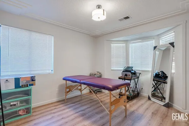 a bedroom with furniture and a wooden floor