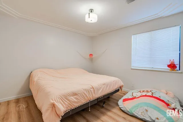 a bedroom with a bed and a dresser