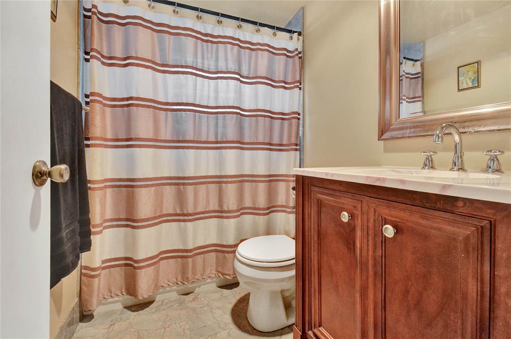 33 Fanshaw A, Unit 33 Boca Raton, FL 33434 - Photo 8 of 16 a bathroom with a sink a toilet and shower