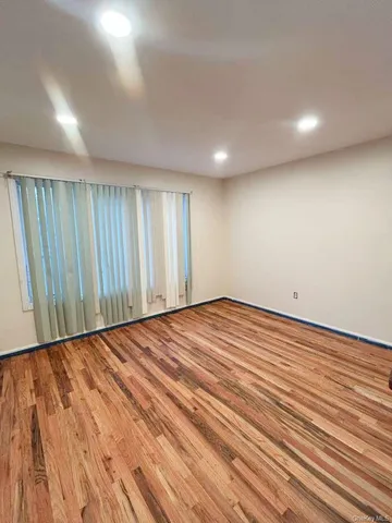 an empty room with wooden floor