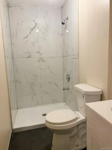 a bathroom with a toilet and a shower