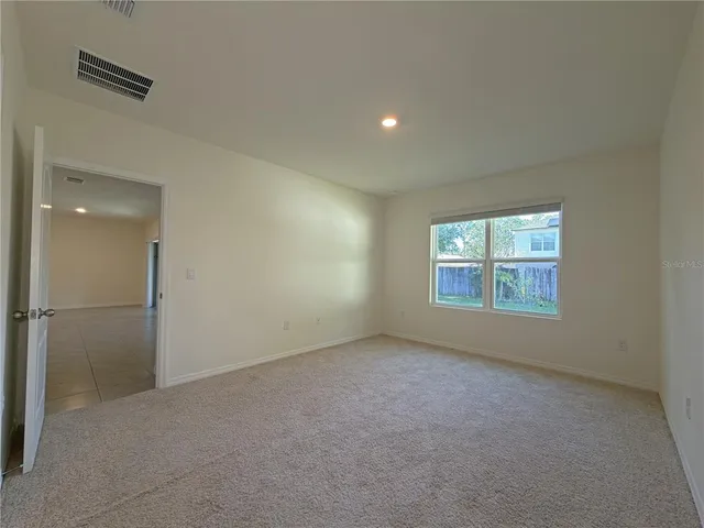 an empty room with a empty space and windows