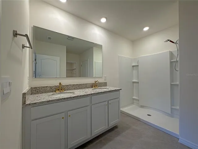 a bathroom with a granite countertop sink mirror and double