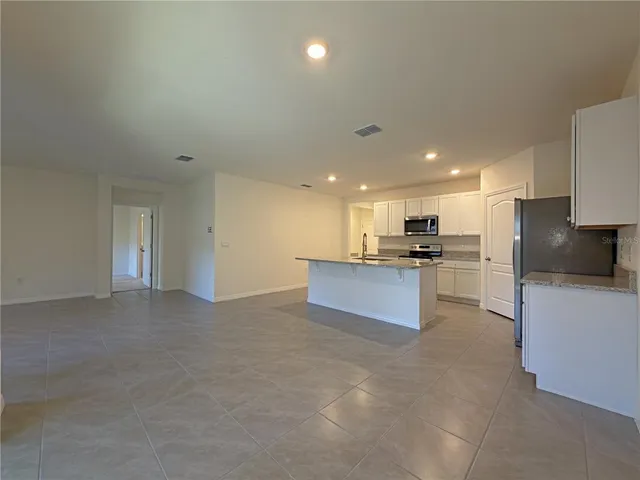 a view of kitchen with kitchen island stainless steel appliances sink and stove